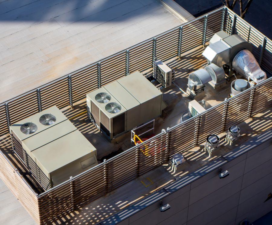 high angle birds-eye view of Manhattan New York City building rooftop with central ac units and ventilation